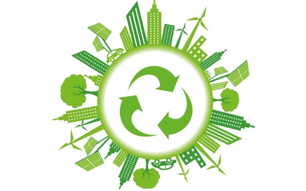 Recycling sign surrounded by tall buildings, wind mills and trees